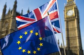 European Union and British Union Jack flag flying in front of Big Ben and the Houses of Parliament at Westminster Palace, London, in symbol of the Brexit EU referendum