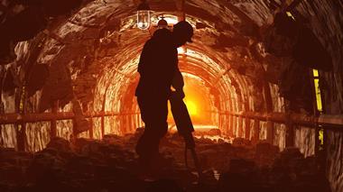 Silhouette of worker in a mine