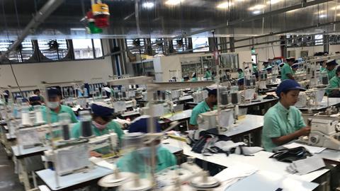 Worker producing clothes in garment factory