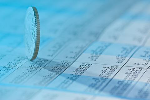 Coins on stock index background 116093056 copy